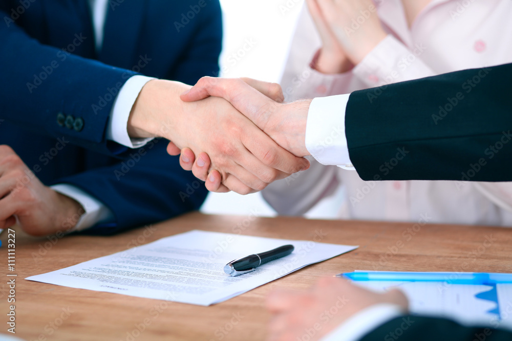 Business people shaking hands finishing up a meeting Business people shaking hands finishing up a meeting