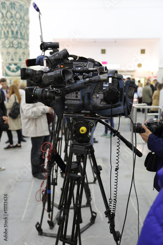 Professional television video cameras on a tripods at the shooting scene