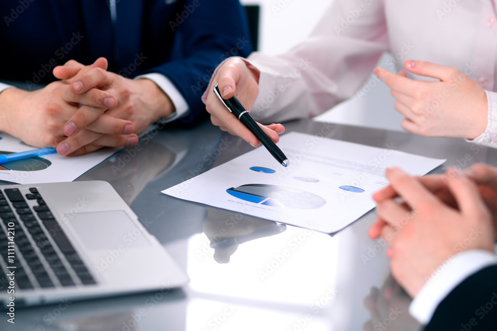 Group of business people at meeting discussing financial results Group of business people at meeting discussing financial results