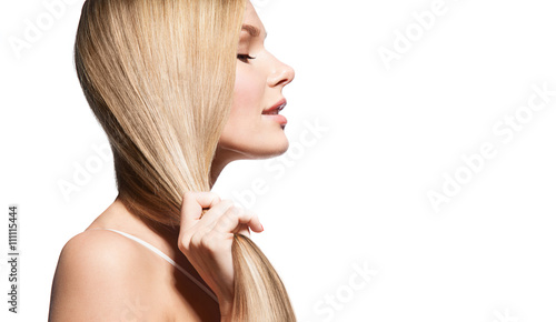 Woman with long thick straight hair on a white background in profile