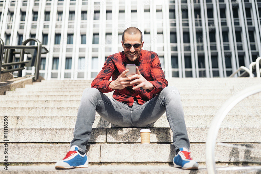 Young man with mobile phone and fixed gear bicycle. Young man with mobile phone and fixed gear bicycle.