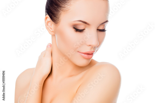 Relaxed sensitive woman with closed eyes touching her neck