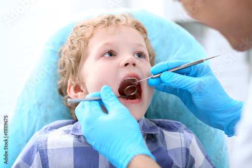 Close up of boy having his teeth examined by a dentist