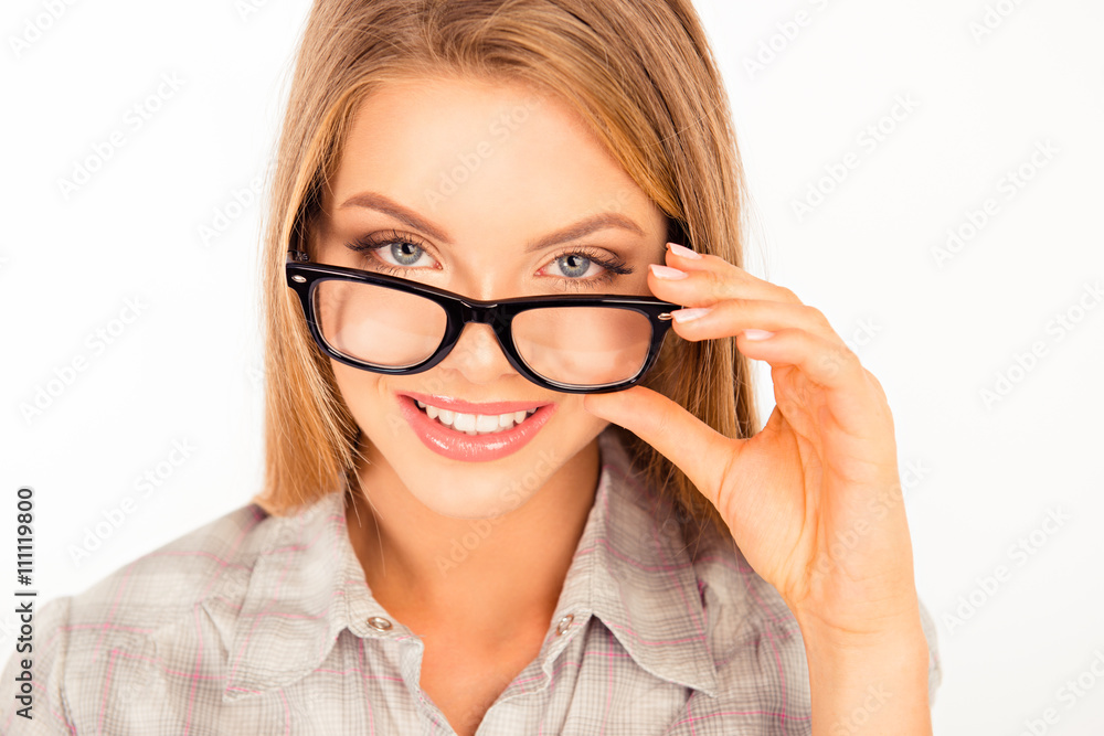 cute young woman adjusting her glasses and smiling cute young woman adjusting her glasses and smiling