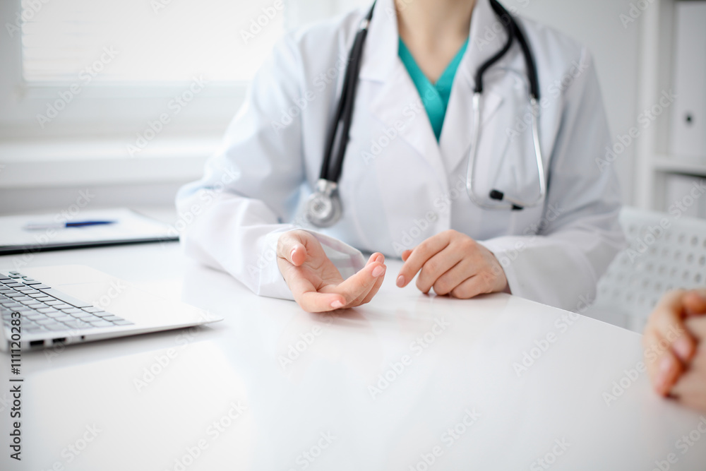 Doctor and patient are discussing something, just hands at the table Doctor and patient are discussing something, just hands at the table