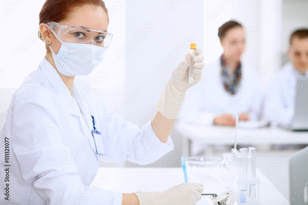 Scientific research team with clear solution in laboratory Scientific research team with clear solution in laboratory