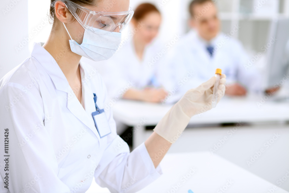 Scientific research team with clear solution in laboratory Scientific research team with clear solution in laboratory