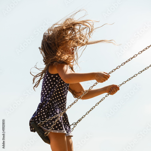Фотография Playful crazy girl on swing.