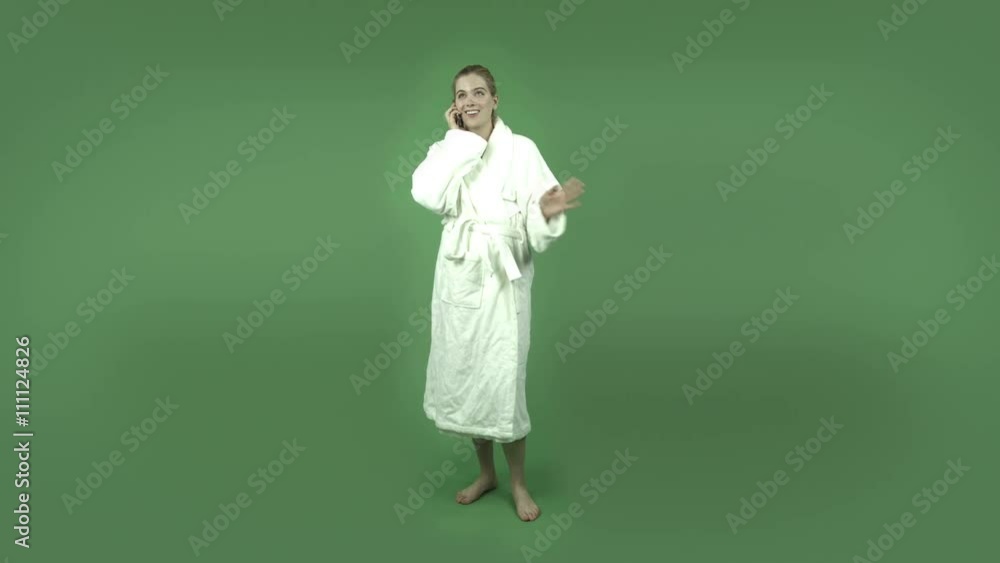attractive caucasian girl in bathrobe isolated on green talking with cell phone attractive caucasian girl in bathrobe isolated on green talking with cell phone