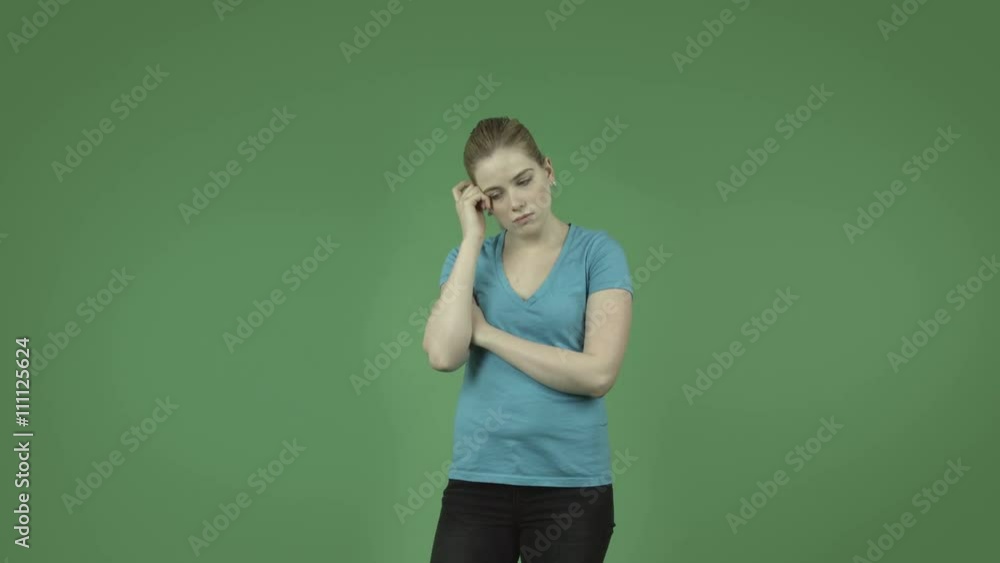 attractive thinking worried caucasian casual girl isolated on green attractive thinking worried caucasian casual girl isolated on green
