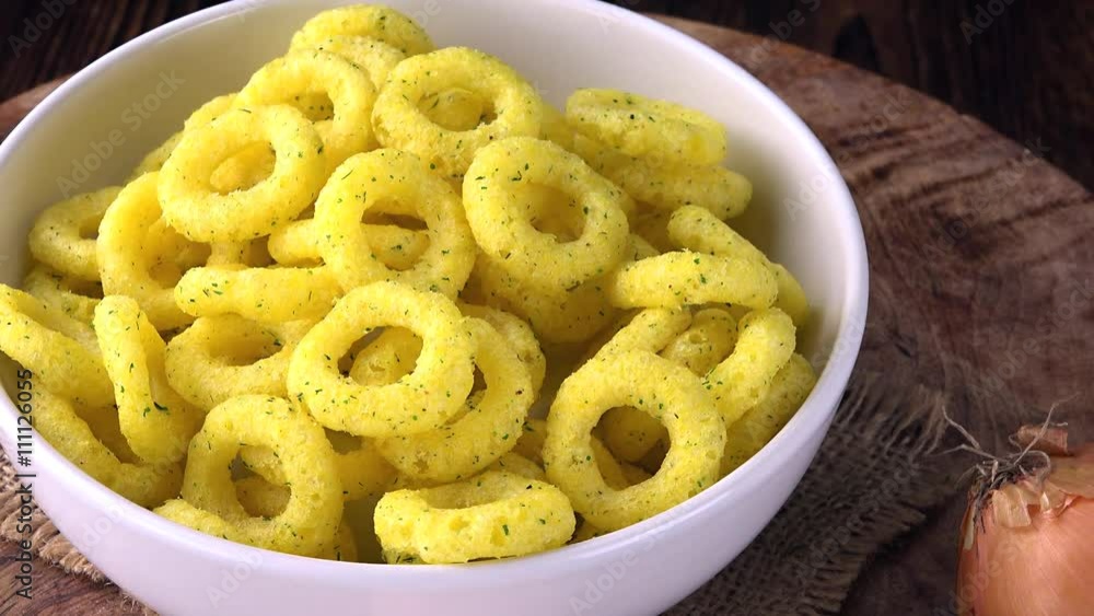 Portion of crispy Onion Snacks as seamless loopable 4K UHD footage Portion of crispy Onion Snacks as seamless loopable 4K UHD footage