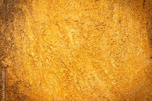 Abstract background texture cement wall in orange yellow tone.