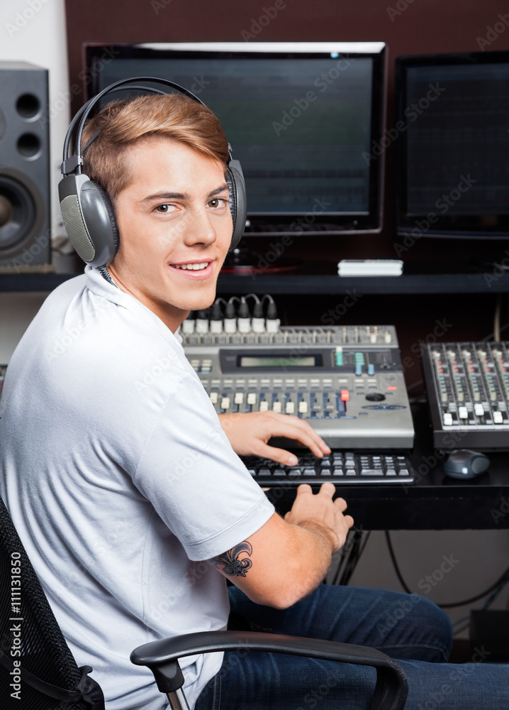 Smiling Young Man Mixing Audio In Recording Studio Smiling Young Man Mixing Audio In Recording Studio