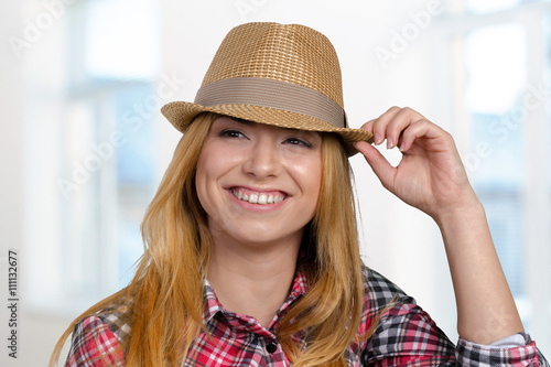 Slim pretty young girl in straw hat