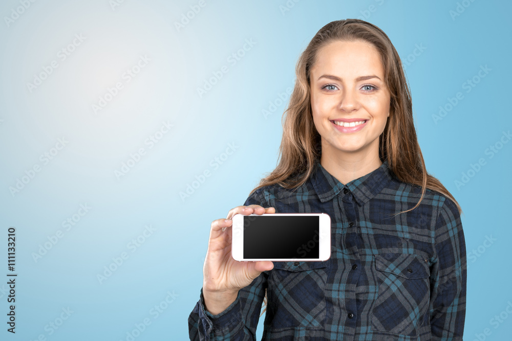 Smiling young woman showing blank smartphone screen Smiling young woman showing blank smartphone screen