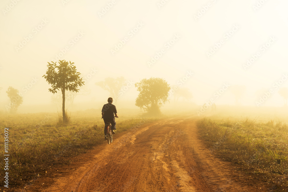 Beautiful Melancholy emotions concept: woemn ride bicycle alone in a lane