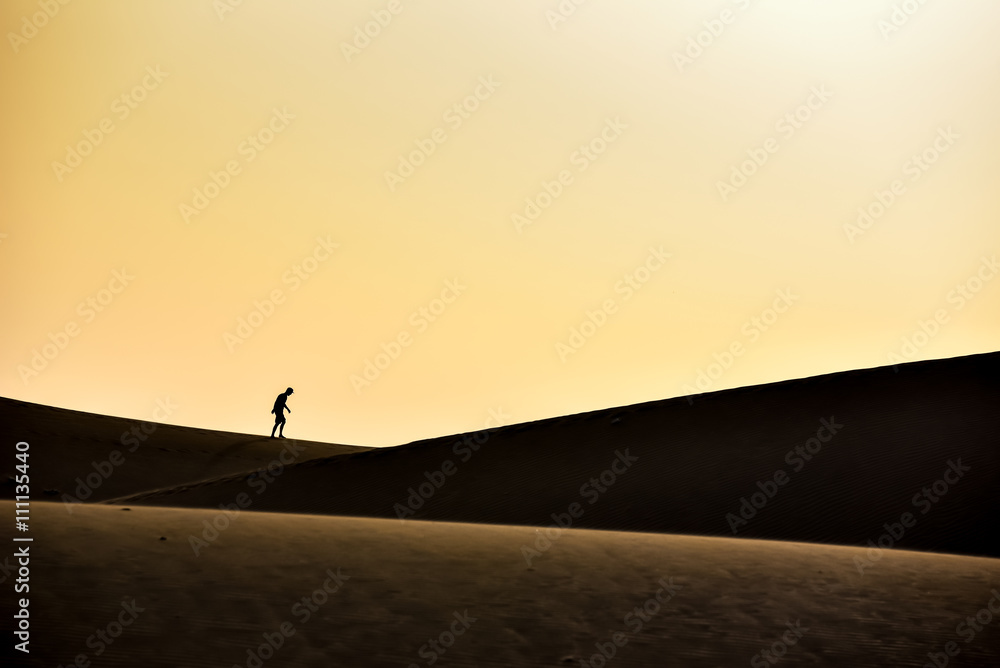 Men walking in the desert of gran canaria, spain Men walking in the desert of gran canaria, spain