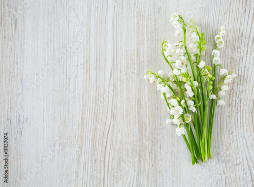 lilies of the valley on the wooden surface