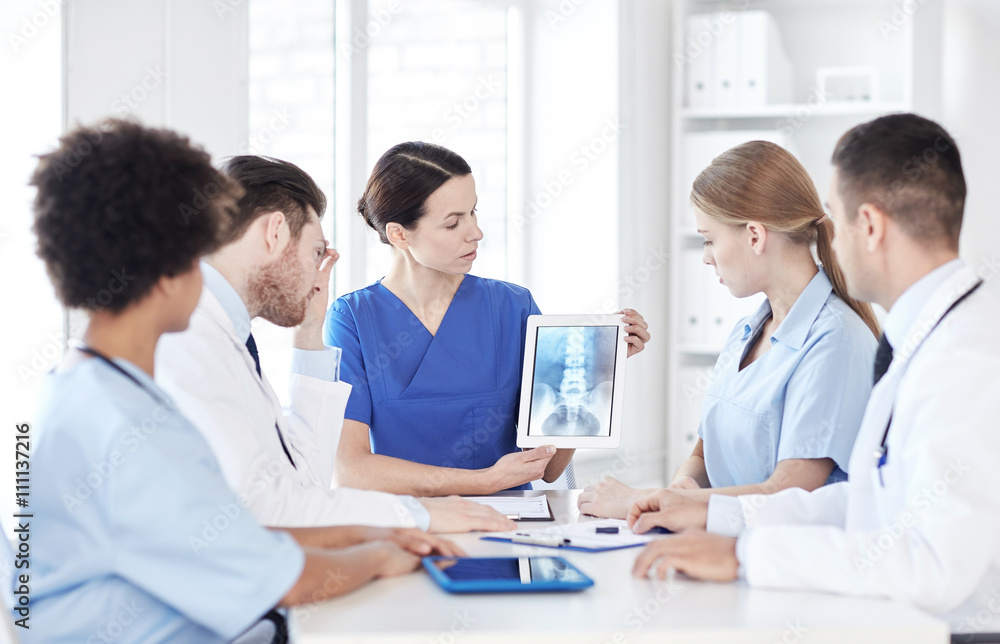 group of doctors with x-ray on tablet pc at clinic group of doctors with x-ray on tablet pc at clinic