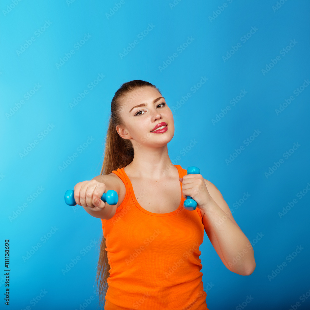 Portrait of a beautiful athletic girl with dumbbells Portrait of a beautiful athletic girl with dumbbells