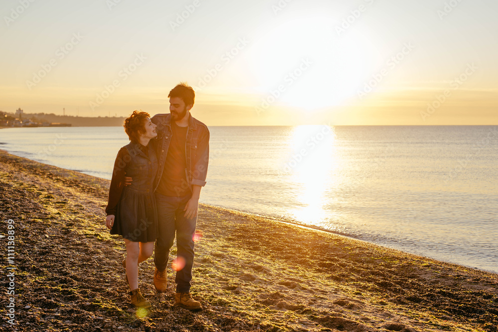 Fototapeta premium happy loving couple having fun on beach at sunset