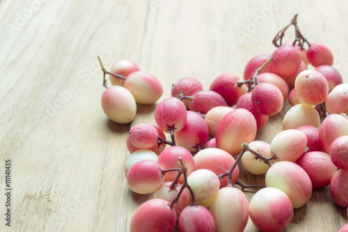 carunda fruit on wooden background