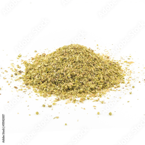 Pile of dried oregano leaves on a white background
