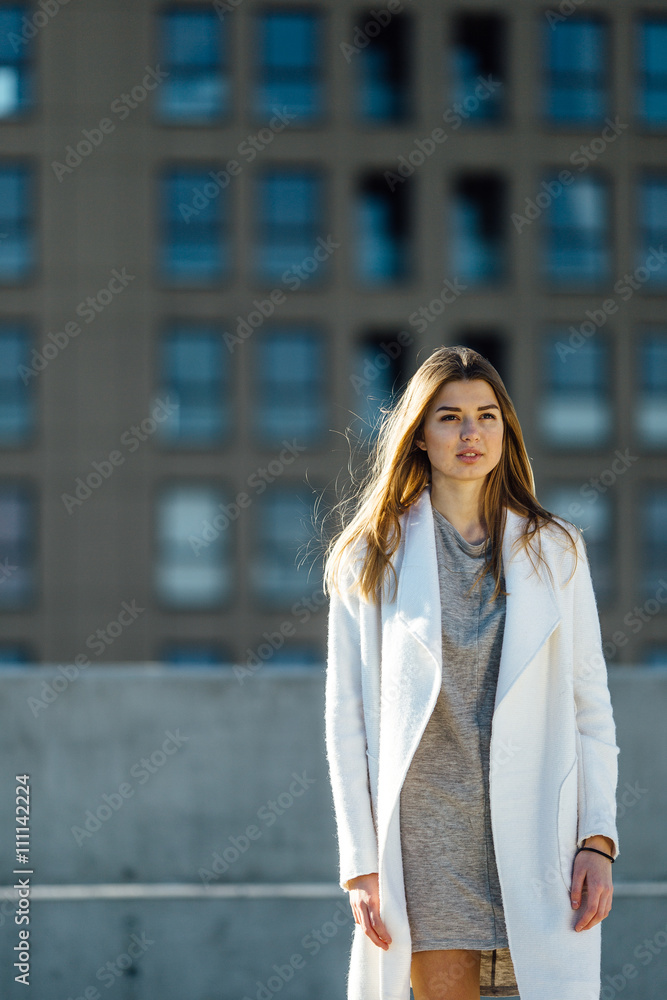 Young pretty girl model posing on the parking