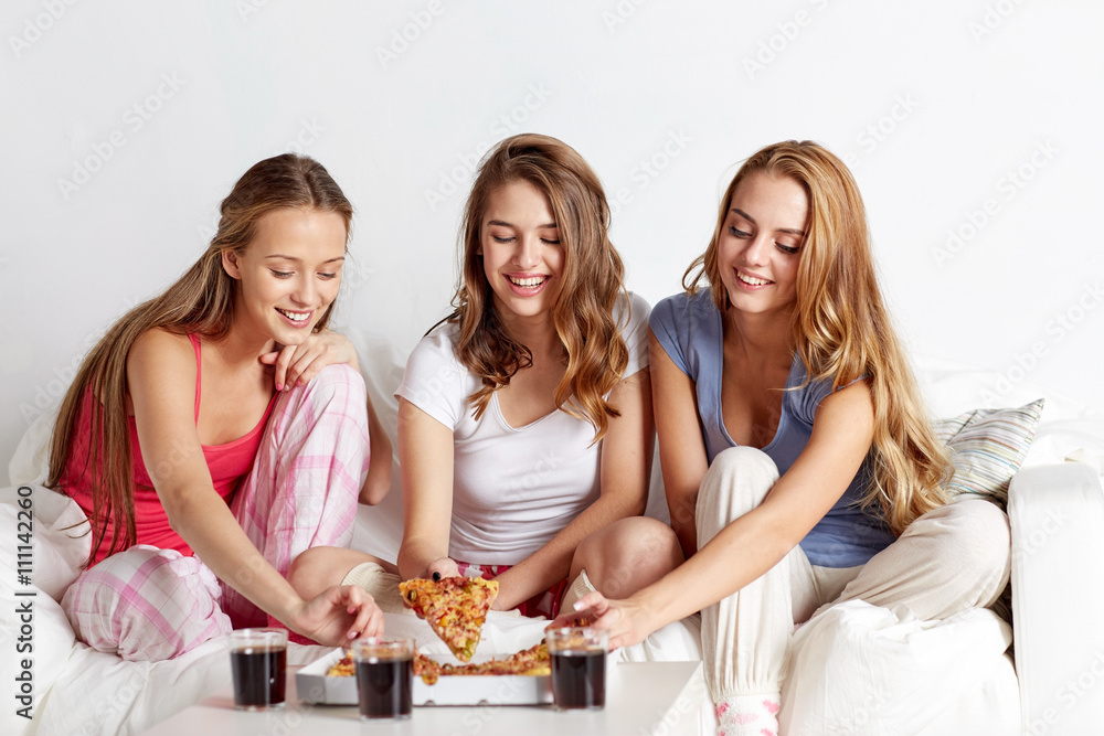 happy friends or teen girls eating pizza at home happy friends or teen girls eating pizza at home