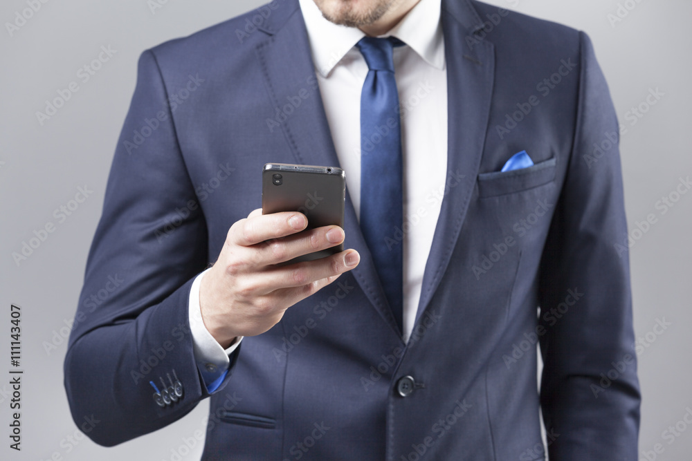 Businessman reading a message on the smart phone Businessman reading a message on the smart phone