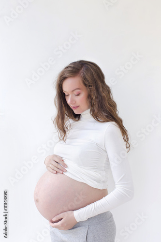 pregnant woman caressing her belly over white Free Download pregnant woman caressing her belly over white - GFXLoad