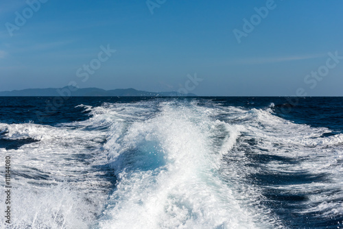 Trail on water surface behind of fast moving motor boat © yotrakbutda