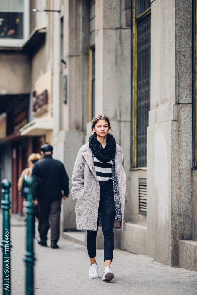 Modern wearing woman walking on the street