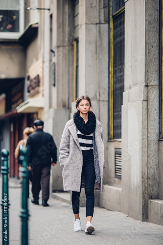 Modern wearing woman walking on the street © Serhiy Hipskyy