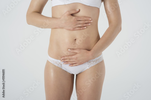 Part of women abdomen with hands