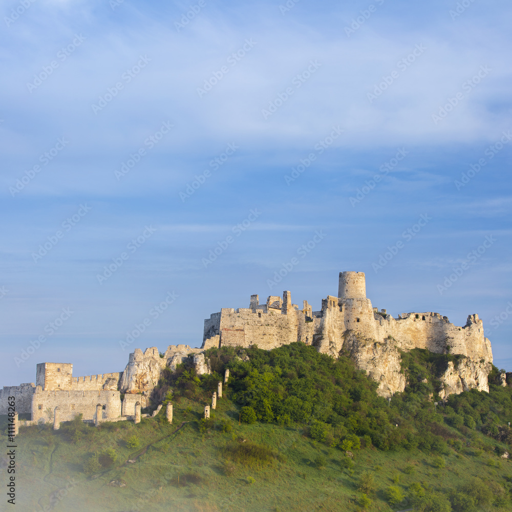 old walls of castle under morning blue sky