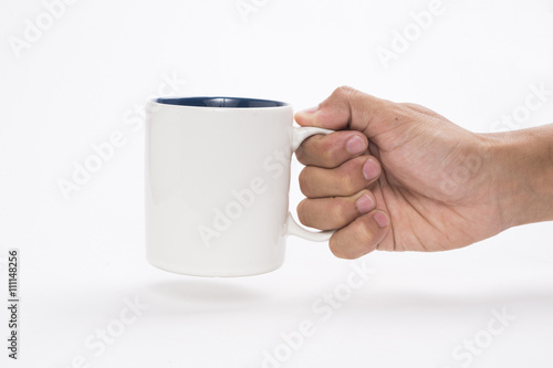 hand holding a mug