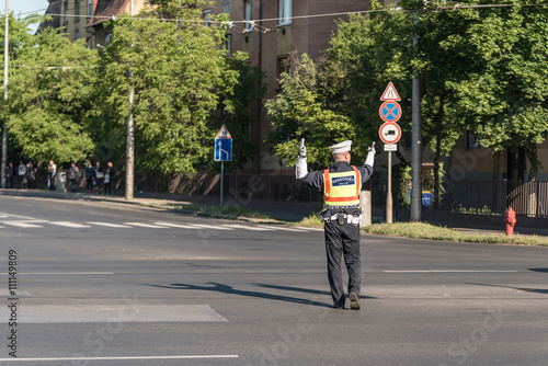 Traffic policeman directing cars in a crossing road