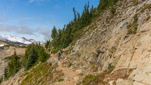 Rocky slopes in the mountains. Amazing view at the peaks which rose against the cloud sky. Path on the tops of mountains. MOUNT FREMONT LOOKOUT TRAIL, Sunrise Area, Mount Rainier