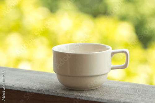 Coffee cup blurry green nature background 