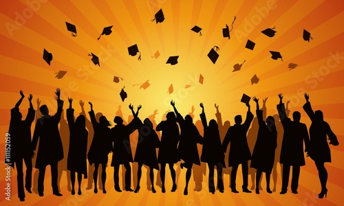 students throwing caps at sunset