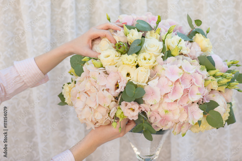 Florist making beautiful bouquet of flowers. Hydrangea, Lisianthus