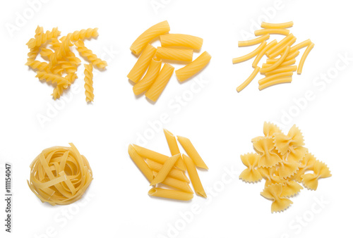 Selection of pasta, uncooked, isolated on white background 