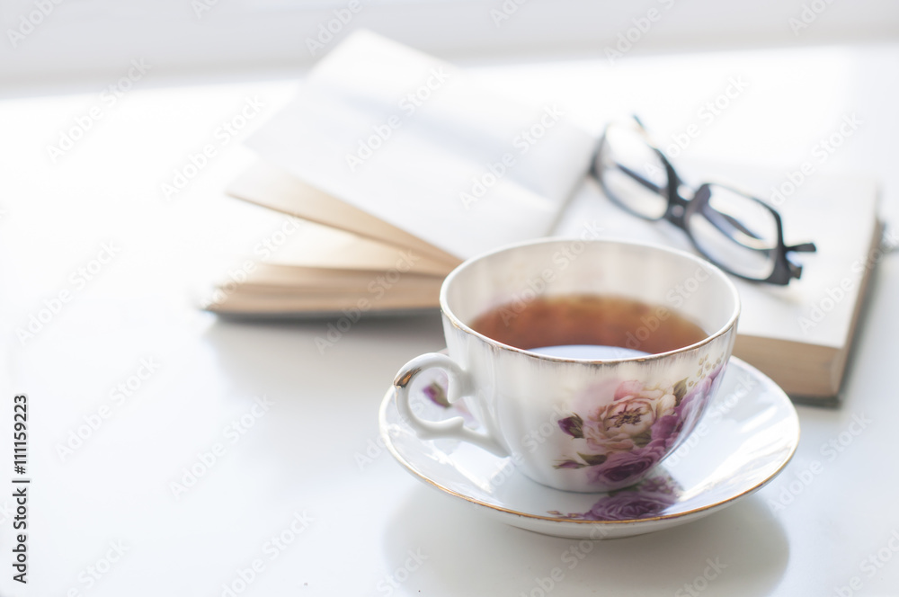 Cup of tea, old book and glasses Cup of tea, old book and glasses