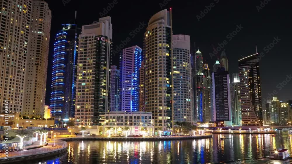 4K Dubai Marina night time lapse, United Arab Emirates. Dubai Marina - the largest man-made marina in the world. Dubai Marina is a canal city, carved along a 3 km stretch of Persian Gulf shoreline 4K Dubai Marina night time lapse, United Arab Emirates. Dubai Marina - the largest man-made marina in the world. Dubai Marina is a canal city, carved along a 3 km stretch of Persian Gulf shoreline