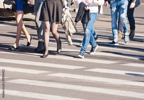 pedestrians walking on a crosswalk outside