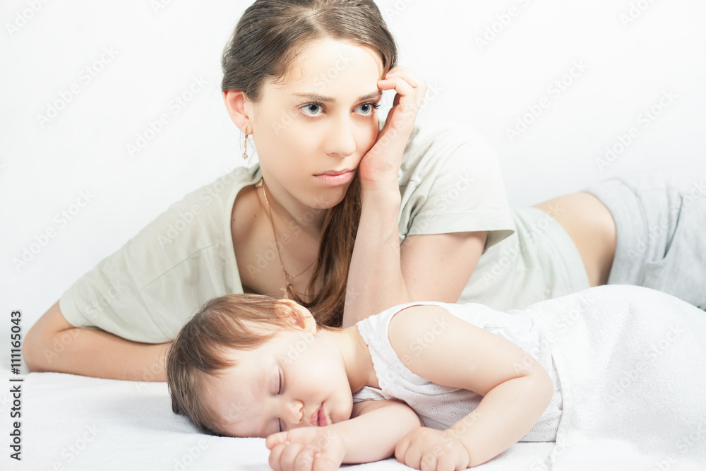 Sad mother with baby. Depressed woman, Sleeping child Sad mother with baby. Depressed woman, Sleeping child