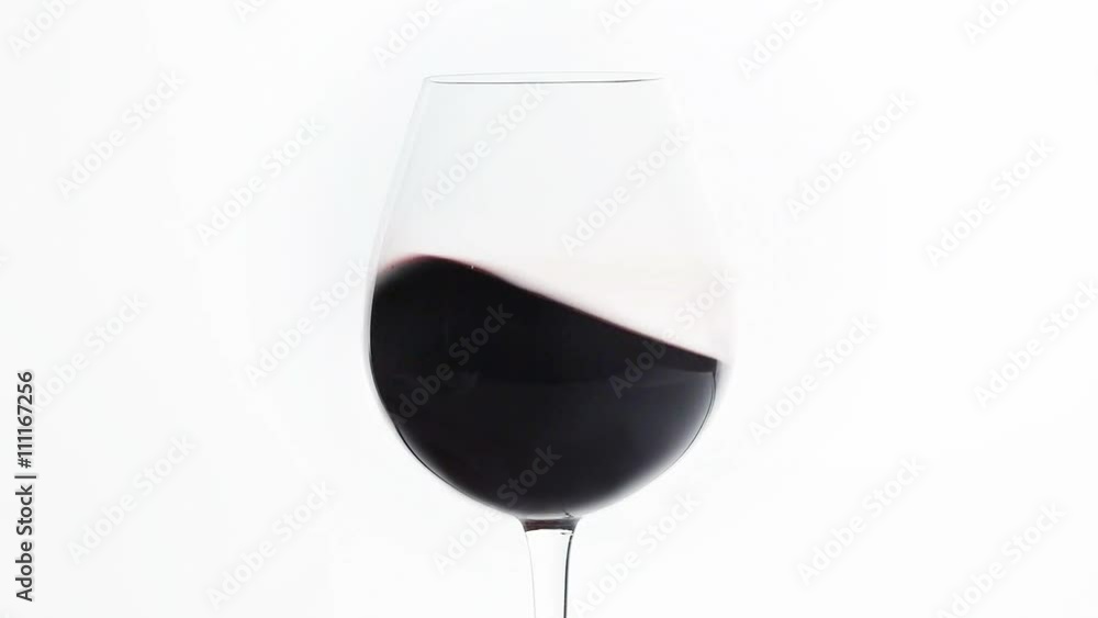 Shaking a baloon wineglass to aerate the red wine. HD cinemagraph Shaking a baloon wineglass to aerate the red wine. HD cinemagraph