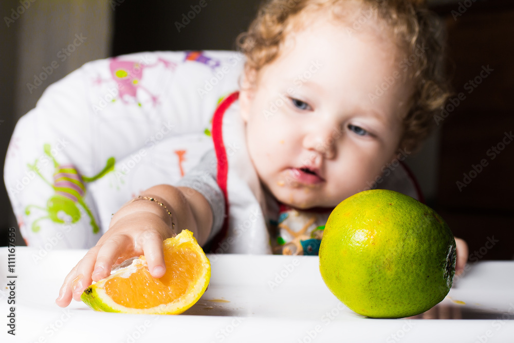 Child eating orange Child eating orange