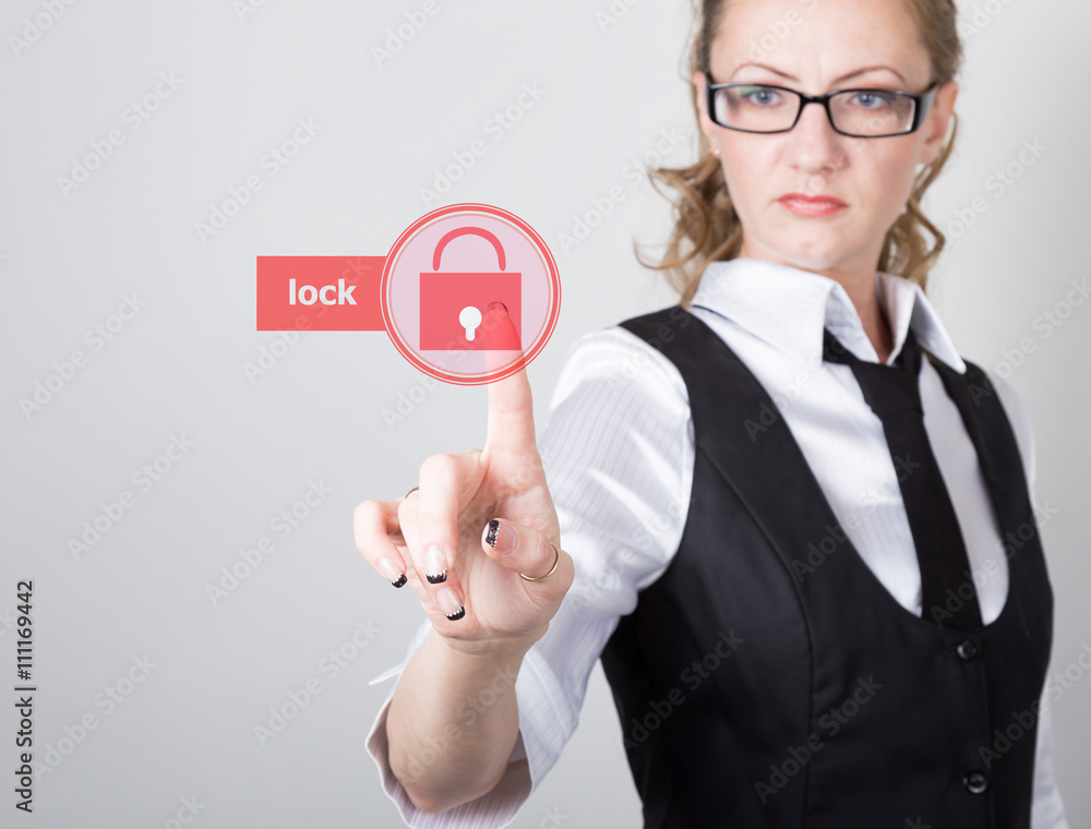 technology, internet and networking concept. beautiful woman in a black business shirt. woman presses lock button on virtual screens technology, internet and networking concept. beautiful woman in a black business shirt. woman presses lock button on virtual screens